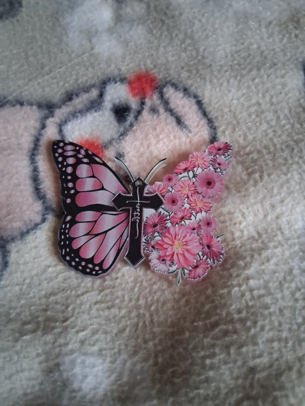 pink butterfly with cross in middle